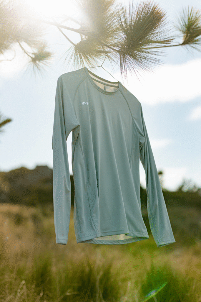  A breathable long-sleeve sun-protection shirt hanging outdoors.